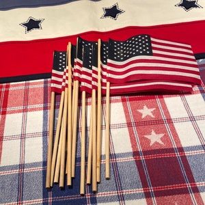 12 small American Flags. New. Unused. 10 inch stick Flag is 6 inches by 4 inch